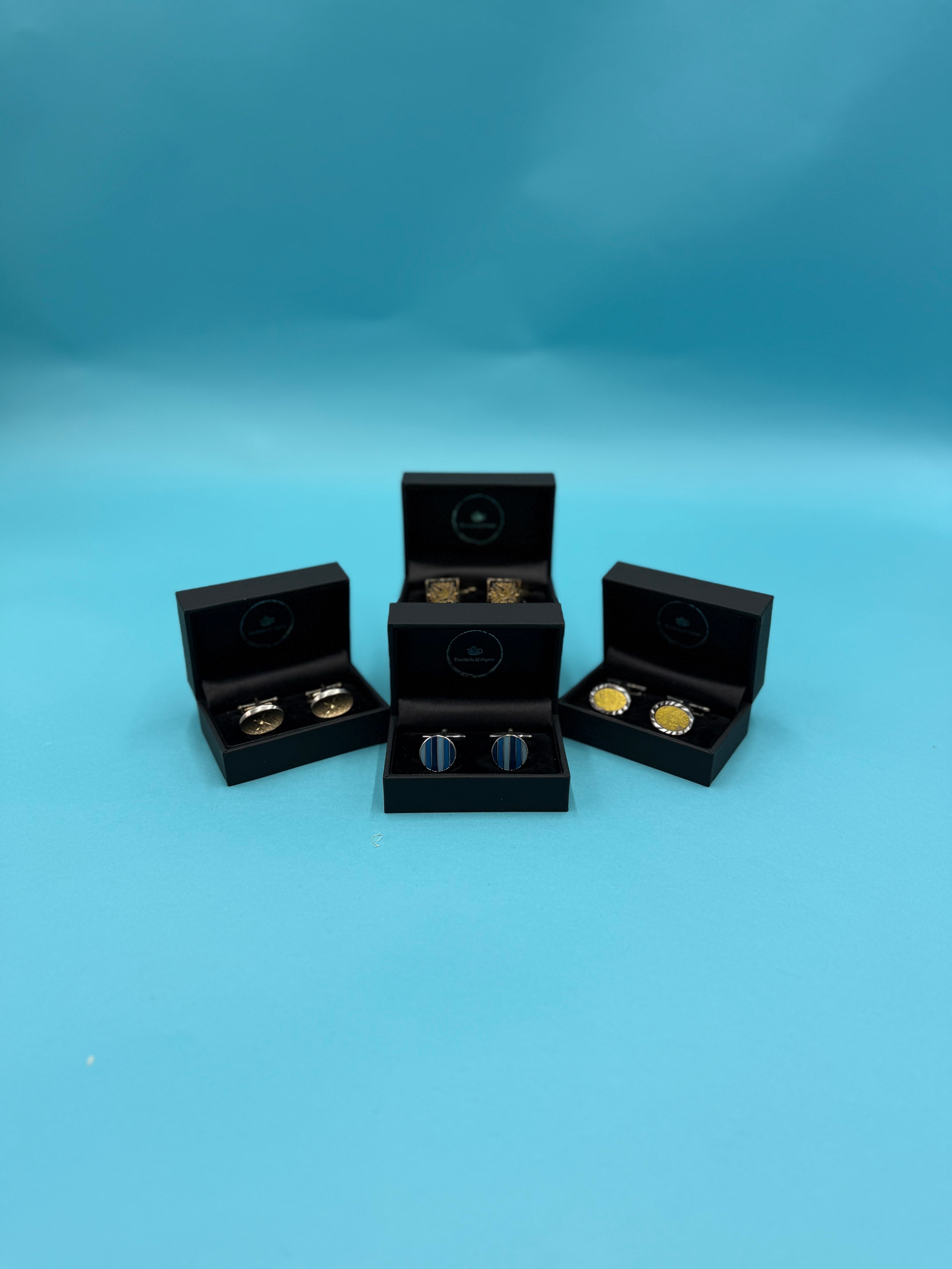 Close-up of diverse vintage cufflinks, destined for a Bluebells & Thyme gift box.