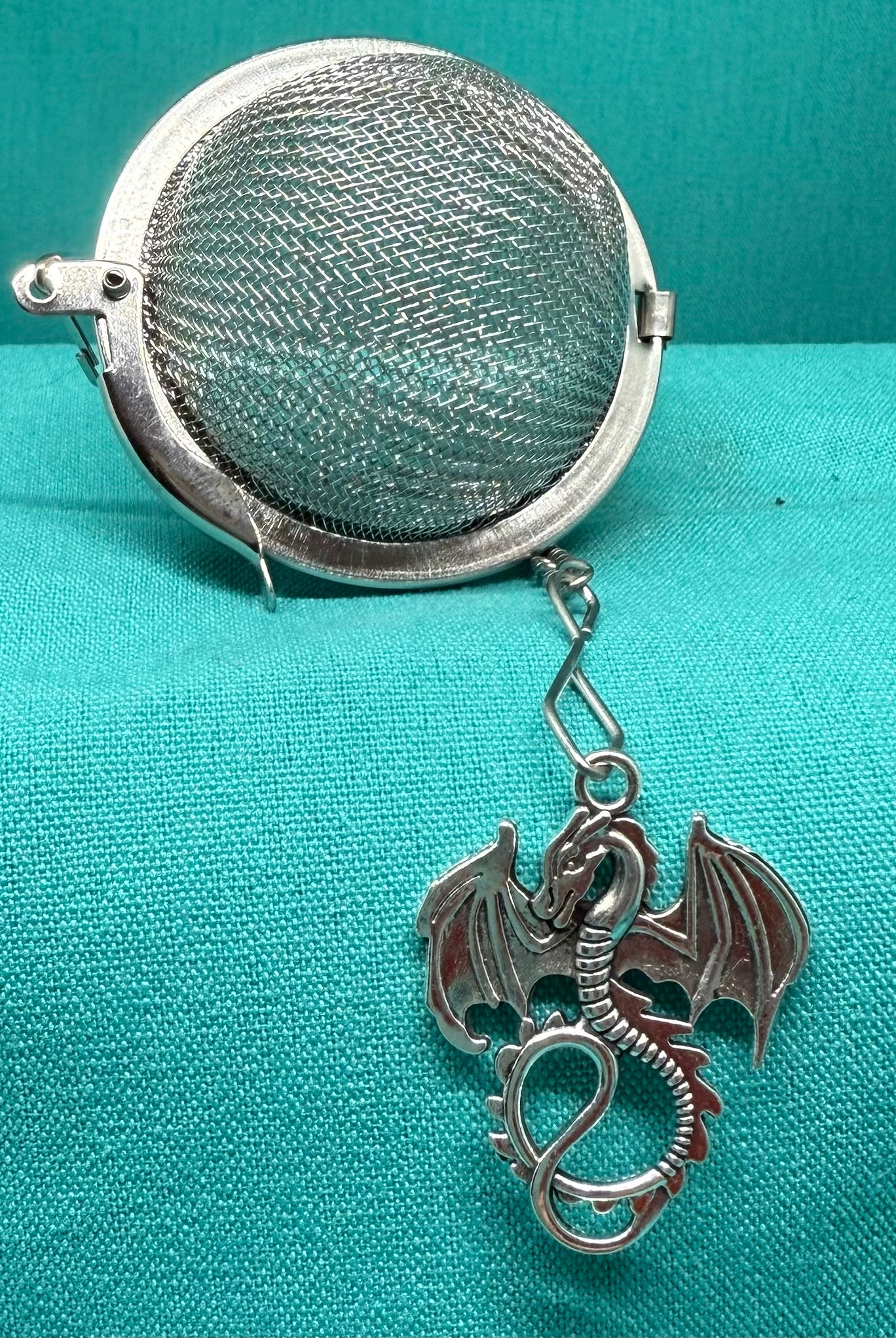 Handcrafted tea strainer by Bluebells & Thyme, featuring a delicate Welsh dragon charm.