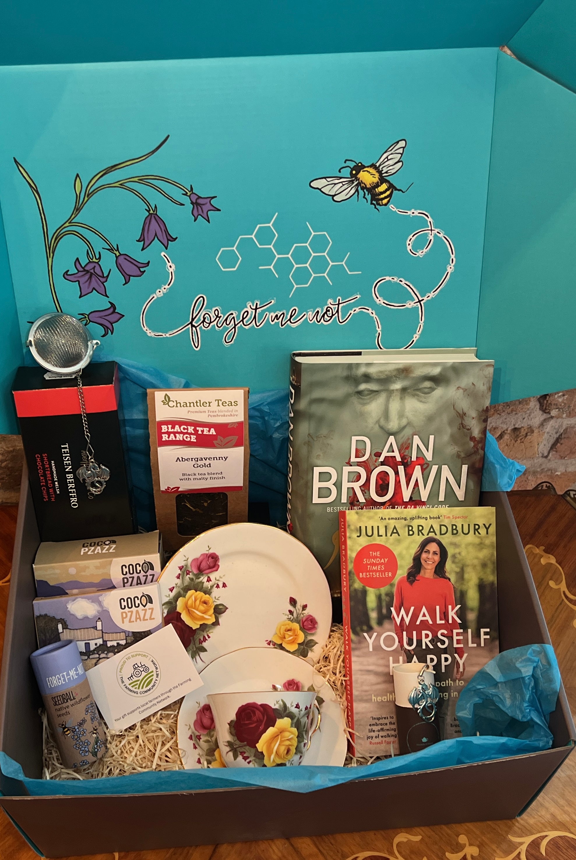 Gift Hamper from bluebells and thyme containing vintage china, artisan food and with books.