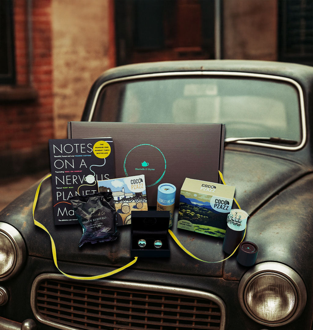 Vintage car bonnet holds 'Just Because' gift box from Bluebells & Thyme, items neatly arranged.