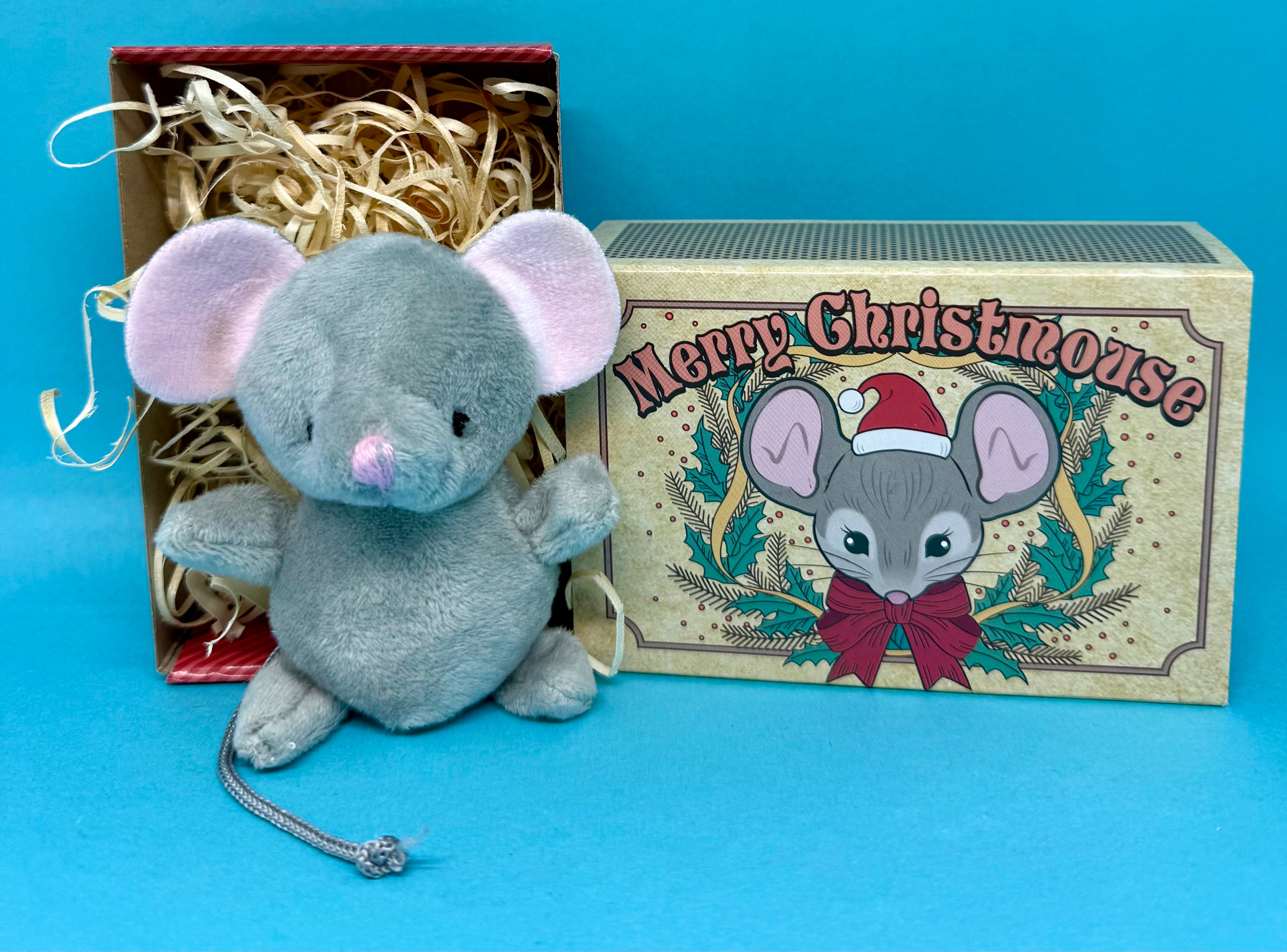 Plush christmas mouse toy with a decorative box featuring 'Merry Christmouse' text on a blue background.