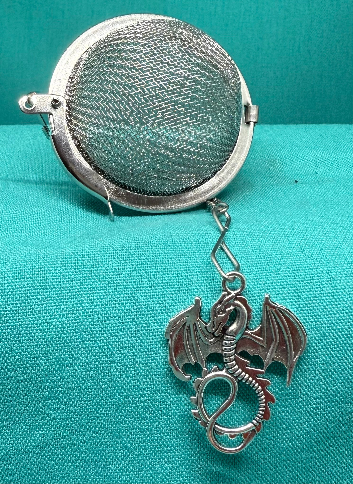 Handcrafted tea strainer by Bluebells & Thyme, featuring a delicate Welsh dragon charm.