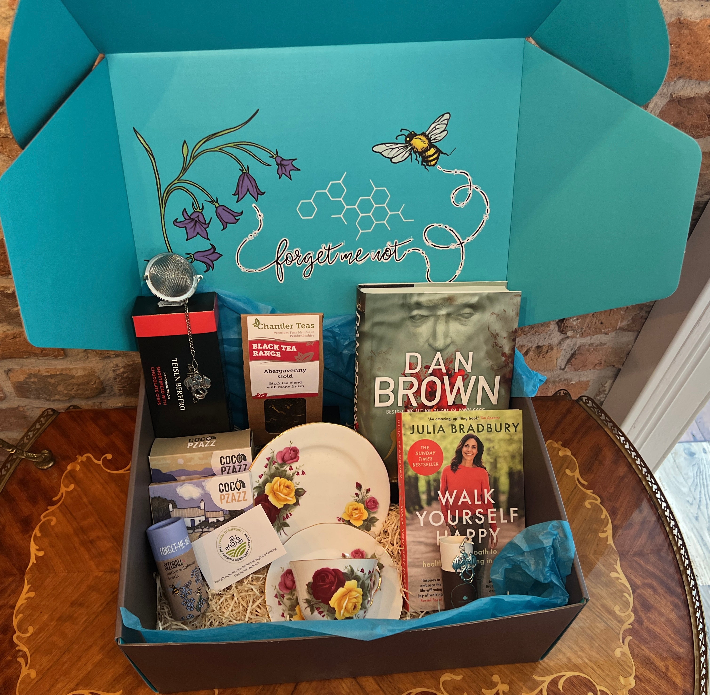 Gift Hamper from bluebells and thyme containing vintage china, artisan food and with books.